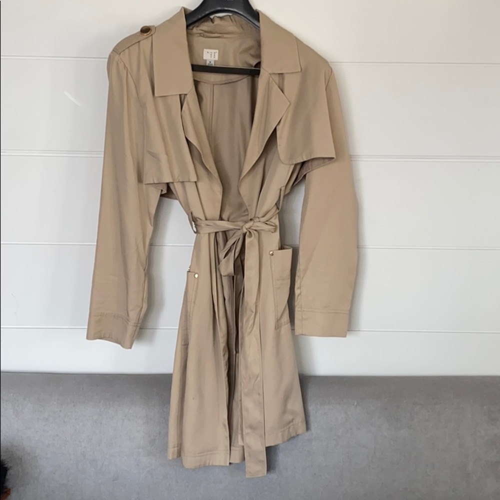 Beige trench coat with gold accents
